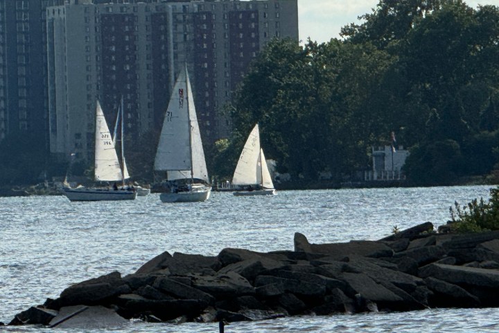 a large body of water with a city in the background